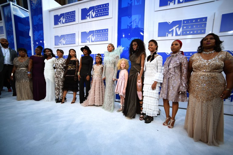 Beyoncé and her guests, mothers of gun violence, on the white carpet (Photo by Larry Busacca / Getty Images)